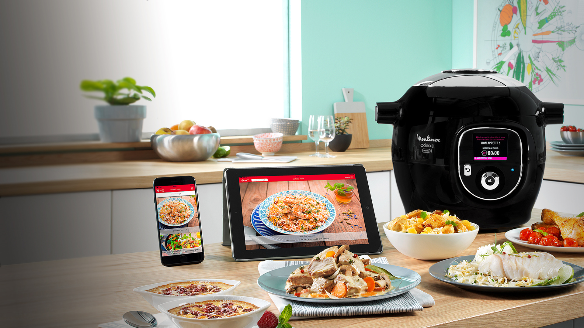 Un Cookeo connecté à son app via un téléphone et une tablette